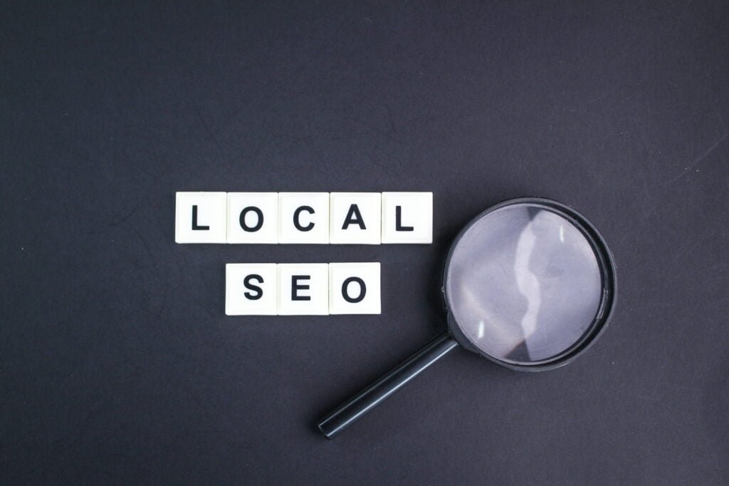 SEO A magnifying glass over the word local AI SEO.