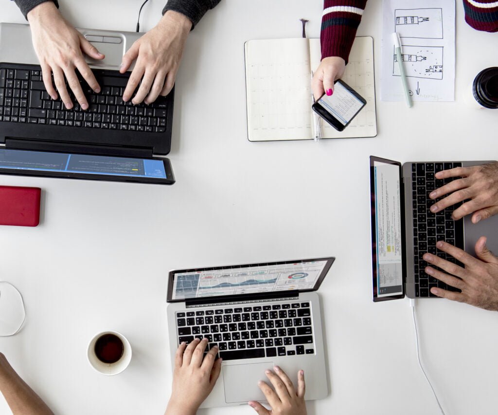 People Hands Working Using Laptop on White Table