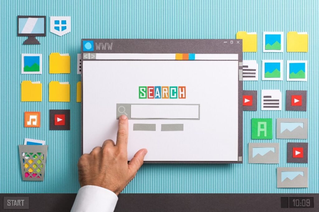 SEO A hand pointing at a search bar on a browser window, surrounded by digital icons and folders on a desktop interface.