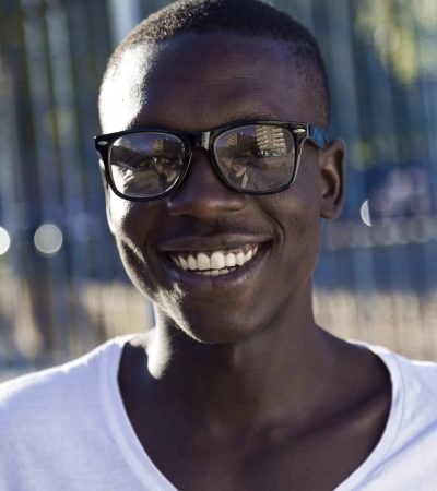 SEO A young black man wearing glasses and a white t shirt. SEO A young black man wearing glasses and a white t shirt.